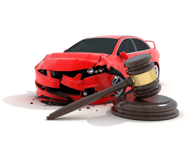 A red sports car with a broken bumper and a wooden gavel in front used for cases like claiming legal damages.