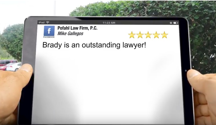 an image of a person holding an ipad with a 5 star review for Pofahl Law Firm